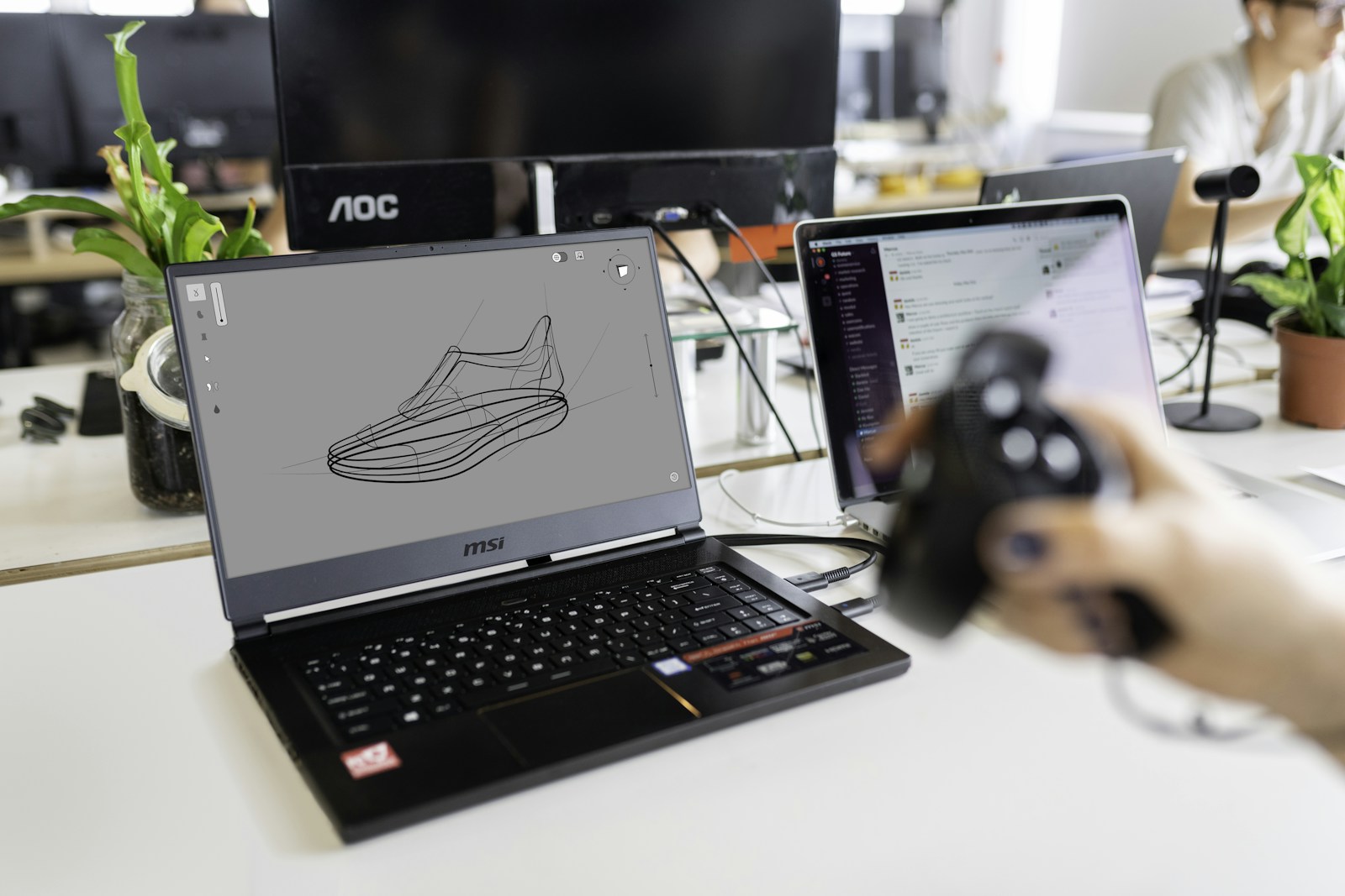 A design engineer testing digital software with a laptop