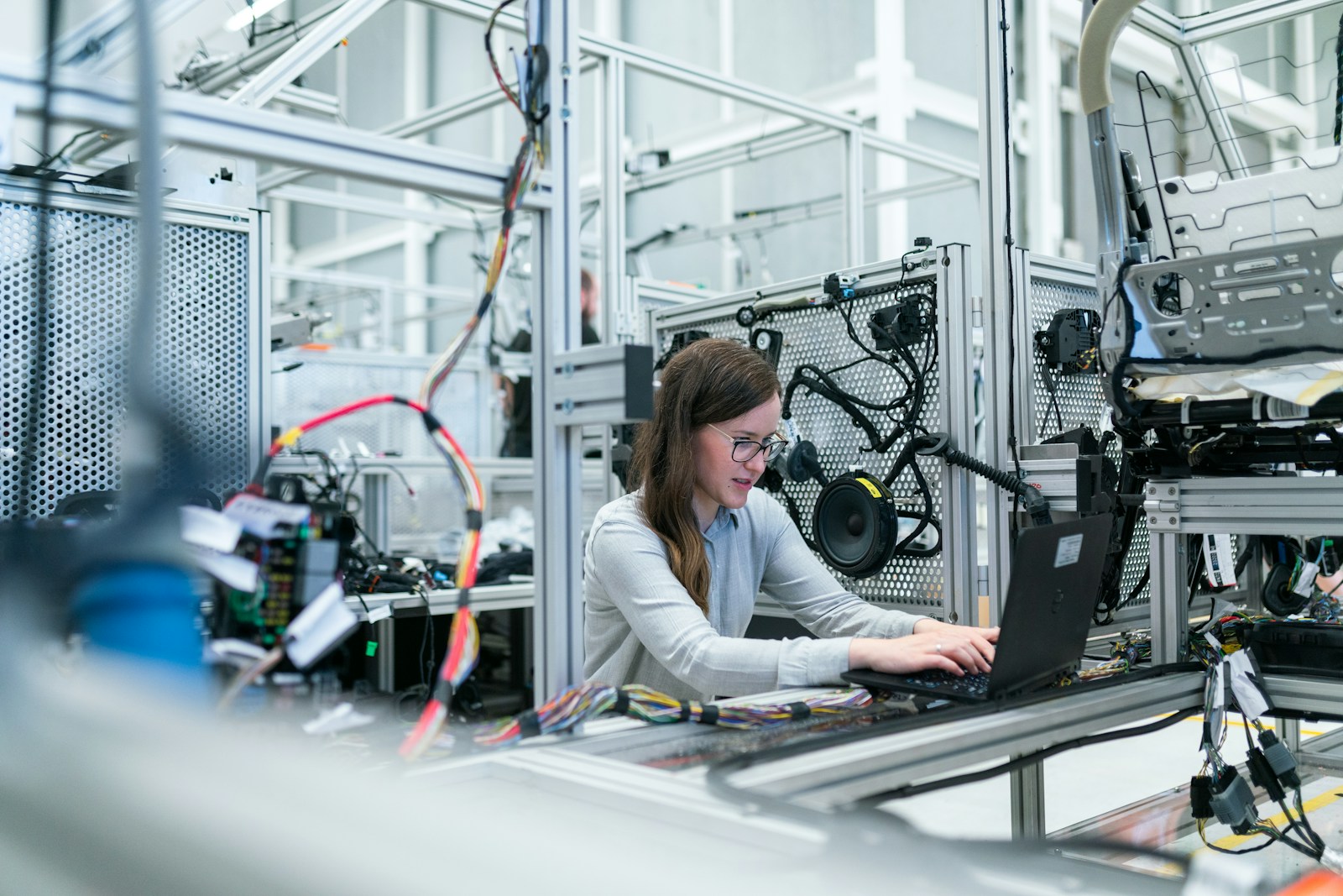 An engineer using a laptop in a technical work setting