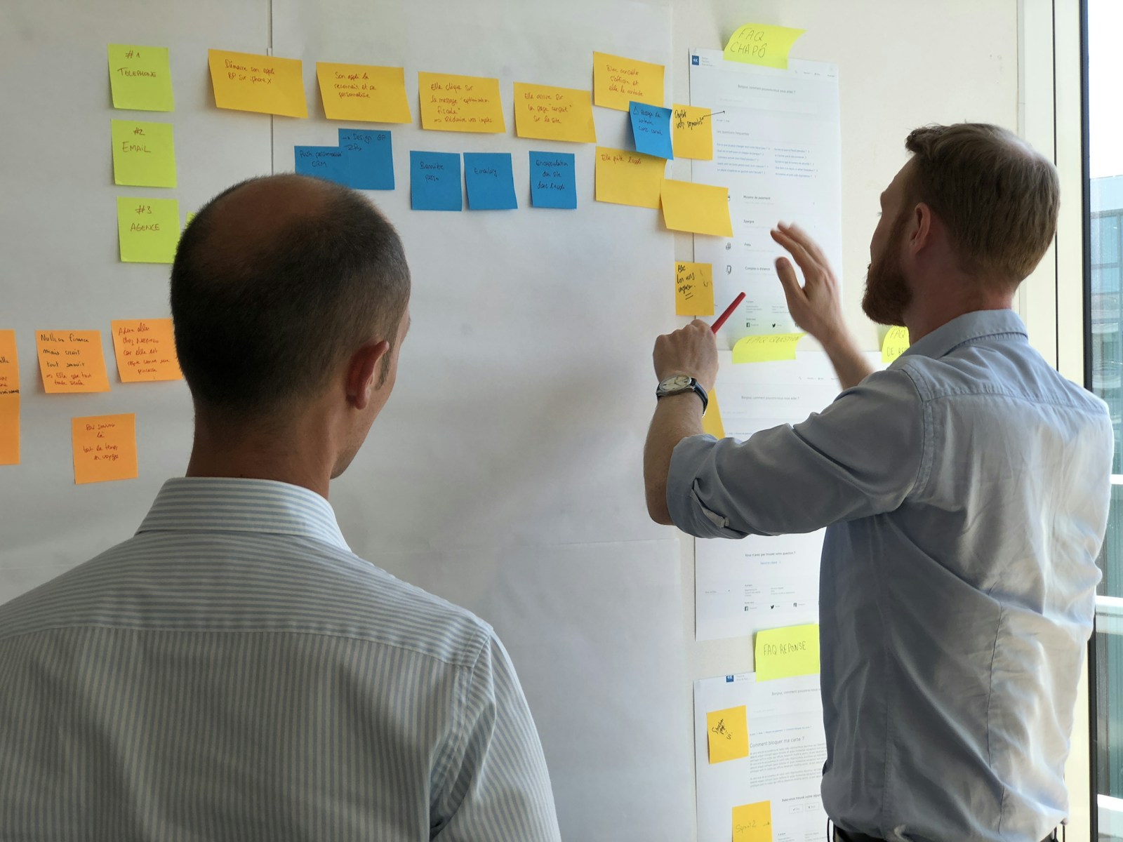 A facilitated workshop with sticky notes and team discussion